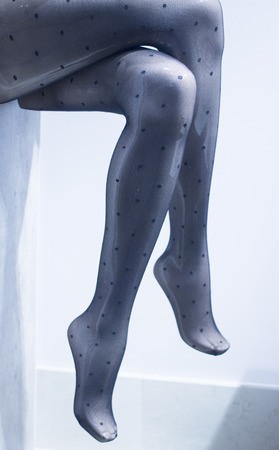 Shop dummy fashion mannequin legs wearing stockings in store boutique shop window photo.の写真素材