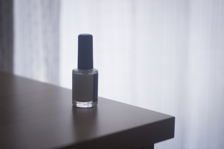 Nail polish varnish bottle on table photo.の写真素材