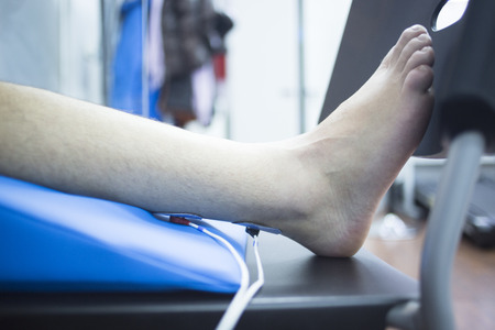 Patient knee, leg, thigh and calf in physiotherapy electrical impulse stimulation rehabiliation...