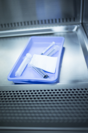 Medical laboratory syringe, sterile swab and tray used for preparation of platelet rich blood plasma human growth factors from blood and plasma that has been centrifuged in hospital clinic for orthopedic surgery and Traumatology rehabilitation treatment iの写真素材