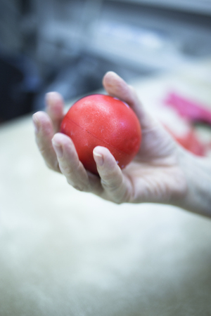 Hand stimulation used to treat pain, muscles injuries, strains and tension in hospital physiotherapy medical rehabilitation clinic for patient using rubber ball exercises.の写真素材