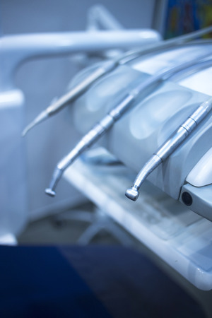 Dental instrumenation dentist drill and cleaning tool in denstists surgery clinic color photo in blue tones.の写真素材