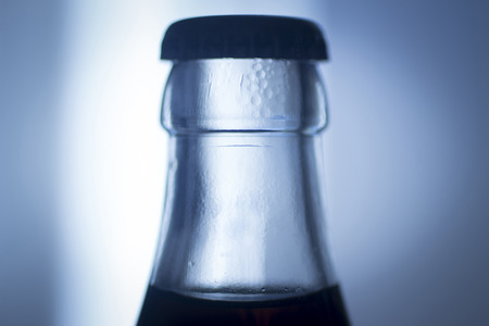 Carbonated soda glass cola soft drink bottle photograph with metal cap.の写真素材