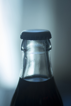 Carbonated soda glass cola soft drink bottle photograph with metal cap.の写真素材