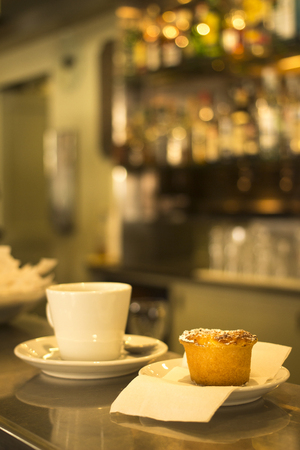 Italian coffee expresso cup spoon and saucer and Italian Budino traditional cake pastry dessert in...