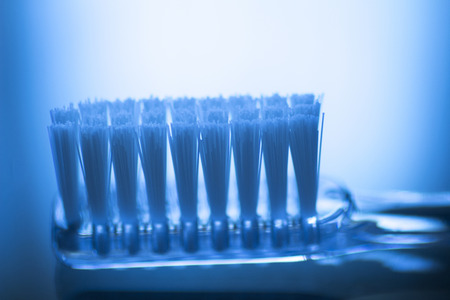 Toothbrush dental hygiene plaque control artistic teeth cleaning dental clinic dentists office surgery color photo in creative blue tones.の写真素材