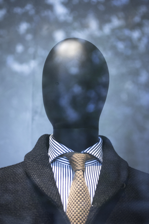 Shop male dummy mens fashion man in shirt and tie mannequin in store boutique shop window artistic photo.の写真素材