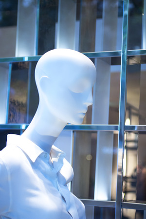 Shop bald dummy fashion mannequin in store boutique shop window artistic photo.の写真素材