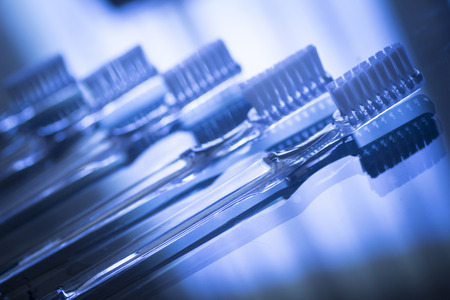 Invisible dental teeth brackets tooth aligners plastic braces retainers to straighten teeth. Othodontic temporary removable straighteners.Artistic color photo in creative blue tones.の写真素材