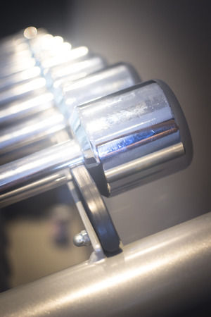 Dumbbell gym metal weights rack in exercise room in sports bodybuilder gym health club fitness studio for bodybuilding and weight training.の写真素材