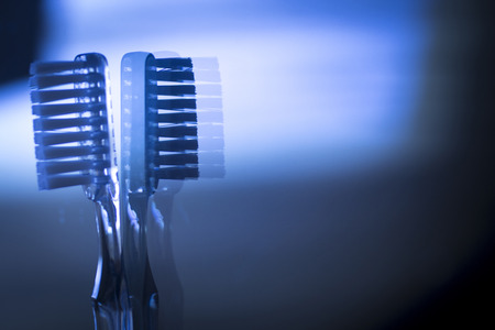 Invisible dental teeth brackets tooth aligners plastic braces retainers to straighten teeth. Othodontic temporary removable straighteners.Artistic color photo in creative blue tones.の写真素材