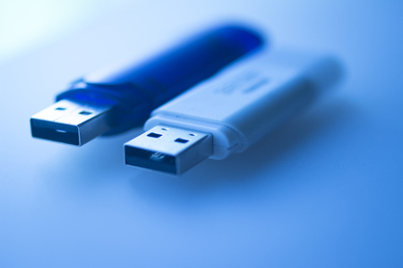 Two USB 3 flash drive III pendrive IT PC memory storage dongle plug socket close-up color artistic...