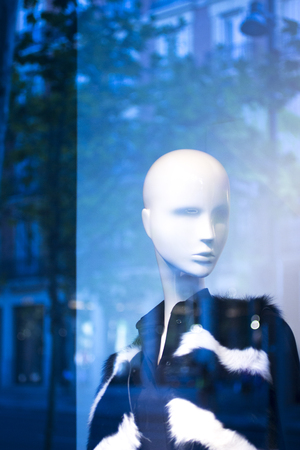 Shop bald dummy fashion mannequin in store boutique shop window artistic photo.の写真素材