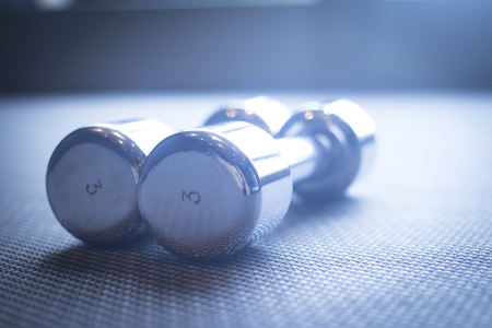 Dumbbell gym metal weights in exercise room in sports bodybuilder gym health club fitness studio for bodybuilding and weight training.の写真素材