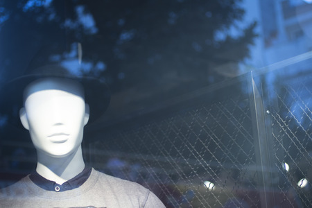 Shop dummy fashion mannequin in store boutique shop window artistic photo.