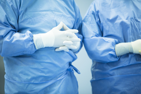 Hospital emergency surgery operating emergency room medical clinic real life photo of hands of surgeon doctor wearing sterile surgical gloves.の写真素材