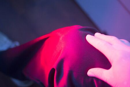 Patient leg knee joint in red physiotherapy heat treatment under hot light.の写真素材