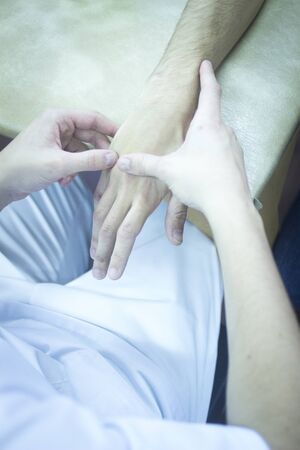 Patient hand in physical therapy physiotherapy clinic in medical center hospital rehabilitation room.の写真素材