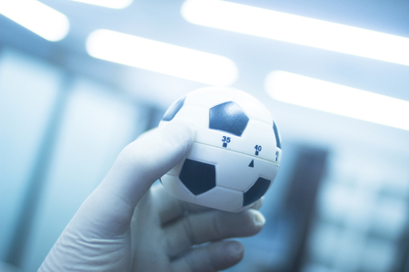 Wrist finger hand strength physiotherapy ball being held and compressed in sports injury physiotherapist medical center.の写真素材