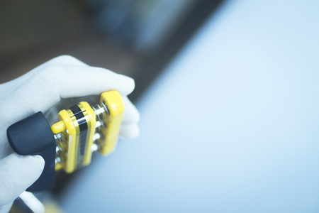 Wrist finger hand strength physiotherapy strengthener being held and compressed in sports injury...