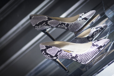 Shop window fashion store designer luxury leather shiny polished shoes.の写真素材