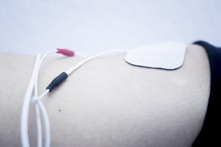Patient leg and knee in electro physiotherapy electrical impulse stimulation rehabiliation treatment...
