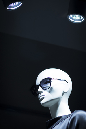 Shop dummy fashion mannequin in department store boutique window wearing current trends in garments.の写真素材