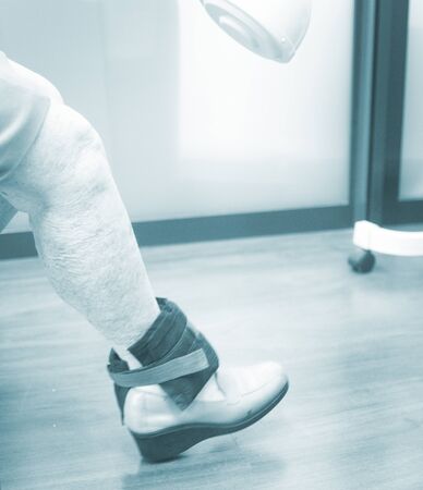 Old woman pensioner female patient leg in physical therapy physiotherapy clinic in medical center hospital rehabilitation room.の写真素材