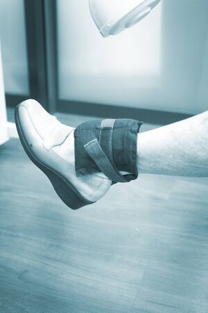 Old woman pensioner female patient leg in physical therapy physiotherapy clinic in medical center hospital rehabilitation room.の写真素材