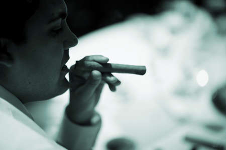 Wedding reception marriage event party man smoking cigar photo.