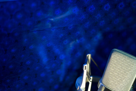 Audio recording vocal studio voice microphone with anti shock mount and built in anti pop filter for singing and voiceover actors doing voiceovers.の写真素材
