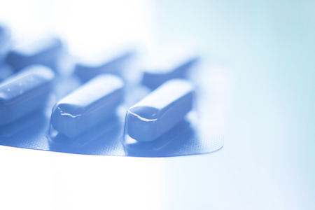 Prescription medication drugs photo. White tablets blister pack of medicine pills isolated.