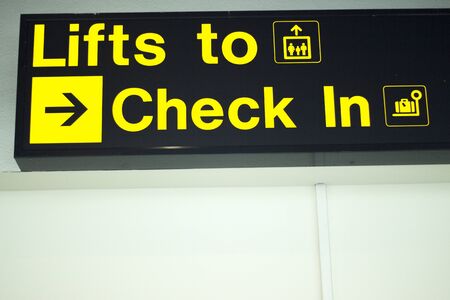 Airport information sign light panel giving directions for checkin for air travelllers.の写真素材