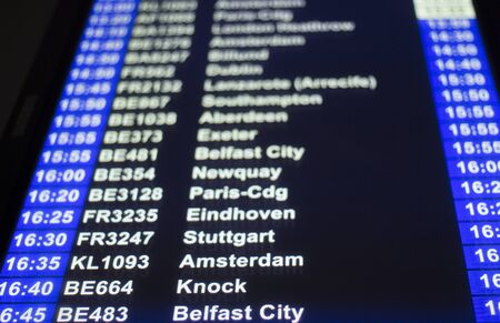 Airport departures arrivals board  light panel board giving information about flights in departure lounge.のeditorial素材