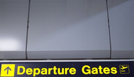 Airport information departures gatessign light panel giving directions in departure lounge.