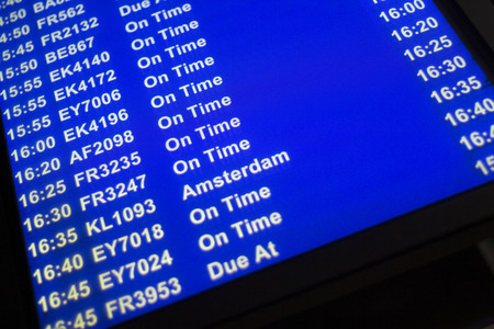 Airport departures arrivals board  light panel board giving information about flights in departure lounge.のeditorial素材