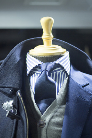Male man shop dummy fashion mannequin in store boutique shop window at night photo.の写真素材