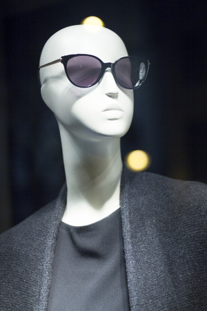 Women's clothes fashion store mannequin wearing black sunglasses and stylish clothing photo.の写真素材