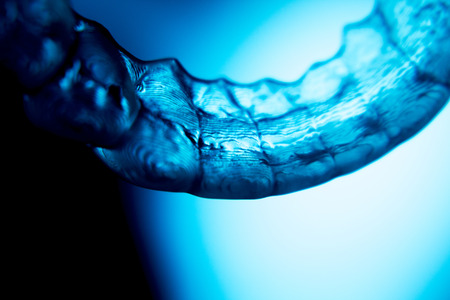 Invisible dental aligners modern tooth brackets transparent teeth braces to straighten teeth in cosmetic dentistry and orthodontics.の写真素材