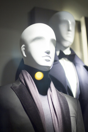 Male man shop dummy men's fashion mannequin in store boutique shop window at night photo.の写真素材