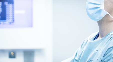 Surgeon in hospital surgery operating room wearing surgical mask photo.