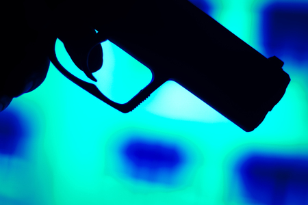 Automatic 9mm pistol handgun weapon in blue photo.の写真素材