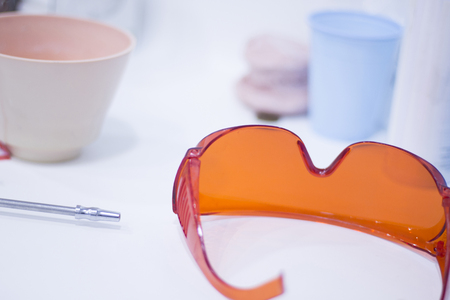 Dentist's glasses protective orange goggles.の写真素材