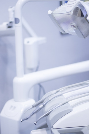 Dentist's chair and dental drill in hospital clinic.の写真素材