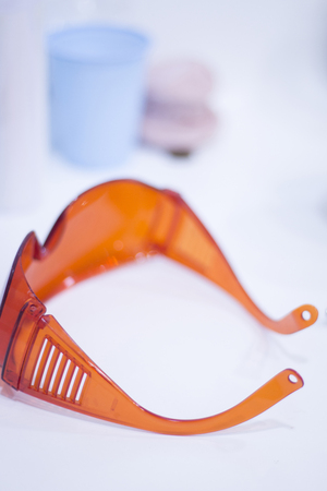 Dentist's glasses protective orange goggles.の写真素材