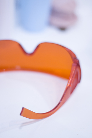 Dentist's glasses protective orange goggles.の写真素材