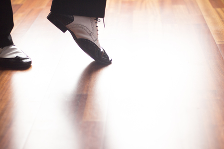 Male ballroom, standard, sport dance, latin and salsa dancer feet and shoes in dance academy school rehearsal room dancing jazz fusion.の写真素材