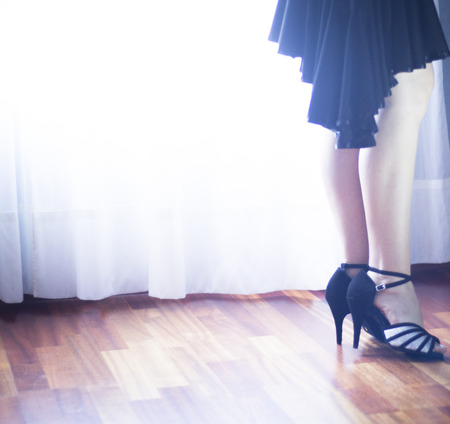 Female ballroom, standard, sport dance, latin and salsa dancer feet and shoes in dance academy school rehearsal room dancing salsa.の写真素材