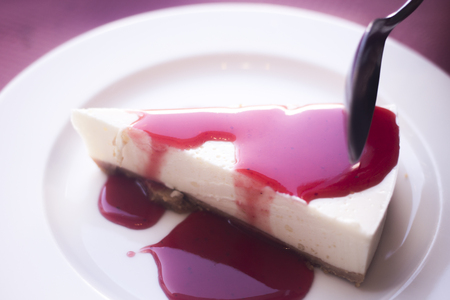 Red fruits cheesecake dessert on plate photo.の写真素材