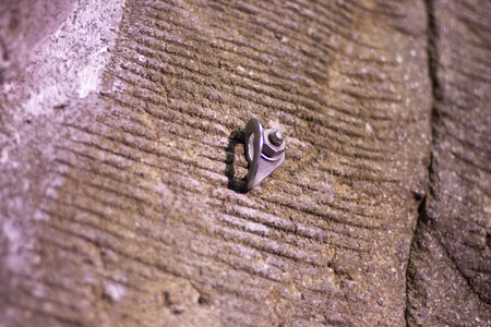 Indoor climbing wall training artificial rock with boulder hand and foot holds for rope attachment in sports center gymnasium.の写真素材